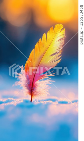 Glowing feather hovers elegantly above pristine snow in bright natural light 125553458
