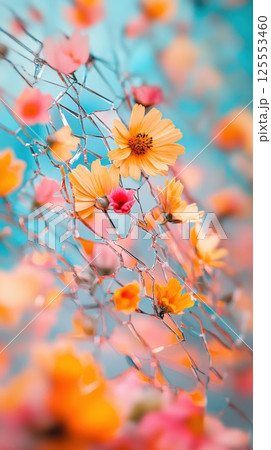 Shattered mirror reflects vibrant flowers blooming from cracks in bright light 125553460