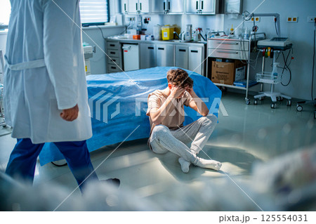 Depressed teenage patient sitting on hospital bed, waiting for doctor. Depressed teenage patient sitting on hospital bed, waiting for doctor. 125554031