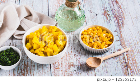 Vegetarian curry with potatoes and cauliflower in a bowl on the table web banner 125555175