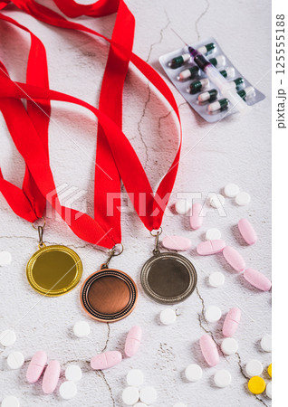 Pill and injections for doping athletes on a light background vertical view 125555188