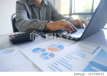 Professional businessman using computer laptop analyzing financial graphs investment marketing data. Professional businessman using computer laptop analyzing financial graphs investment marketing data. 125556523