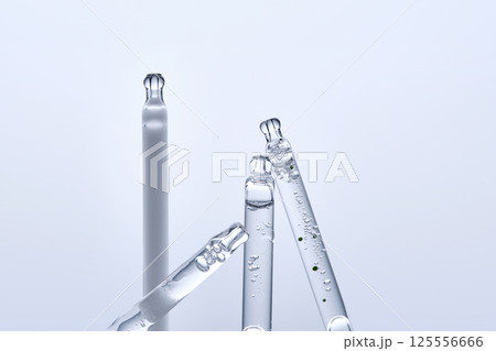Four different droppers with facial serum in a row. 125556666