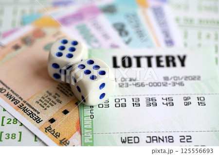 Green lottery tickets and indian rupees money bills on blank with numbers for playing lottery 125556693