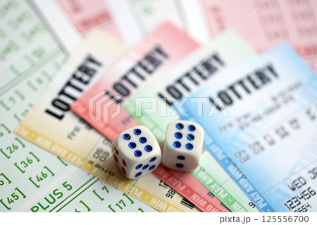 Lottery tickets of different colors and dice on blank bills with numbers for playing lottery Lottery tickets of different colors and dice on blank bills with numbers for playing lottery 125556700