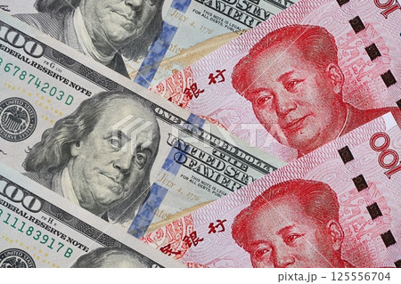 Many money bills of People Republic of China and United States. PRC Yuan and USD dollars 125556704