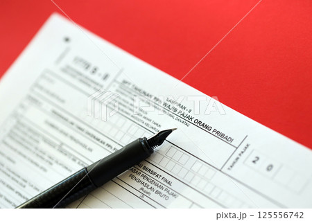 Indonesian tax form 1770 S - 2 Individual Income Tax Return and pen on table Indonesian tax form 1770 S - 2 Individual Income Tax Return and pen on table 125556742