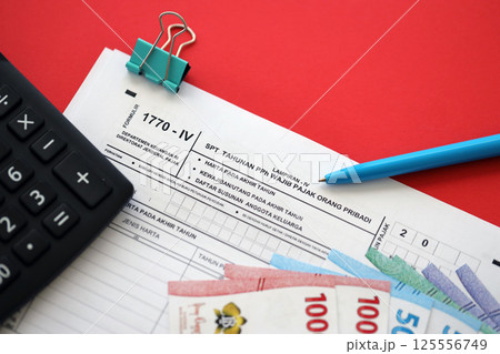 Indonesian tax form 1770-4 Individual Income Tax Return and pen on table Indonesian tax form 1770-4 Individual Income Tax Return and pen on table 125556749