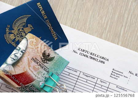 Kartu keluarga Family Identity Card with indonesian passport and bunch of indonesian rupiah bills Kartu keluarga Family Identity Card with indonesian passport and bunch of indonesian rupiah bills 125556768
