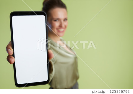 Blurred woman promoting smartphone app 125556792