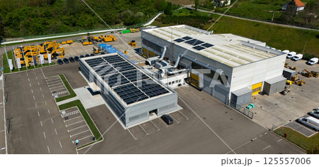 Solar powered construction machinery distribution and service center. Aerial view 125557006