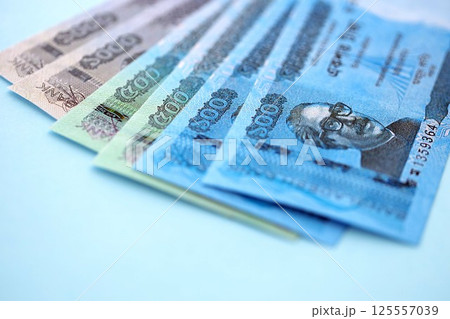 Bangladeshi taka money bills in big amount lies on teal color table close up Bangladeshi taka money bills in big amount lies on teal color table close up 125557039