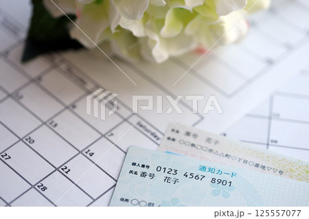 Japanese my number card specimen and notification card on calendar background Japanese my number card specimen and notification card on calendar background 125557077