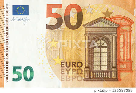 Fragment of one fifty euro money bill. Details of European union currency banknote of 50 euro 125557089