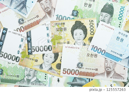 South Korean won money bills in big amount lies on white color table close up South Korean won money bills in big amount lies on white color table close up 125557263