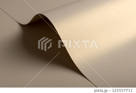 Paper background with matte texture. Curved wave shape in golden, beige, and light brown tones, Paper background with matte texture. Curved wave shape in golden, beige, and light brown tones, 125557711