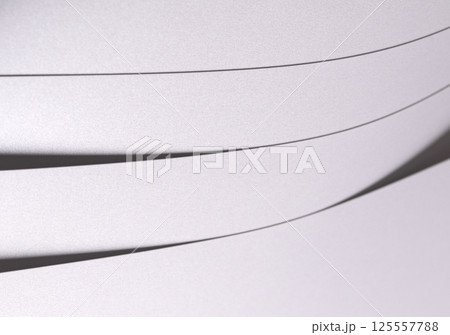 White pearl paper background with a satin, glossy texture and softly curved layered strips. Pale 125557788
