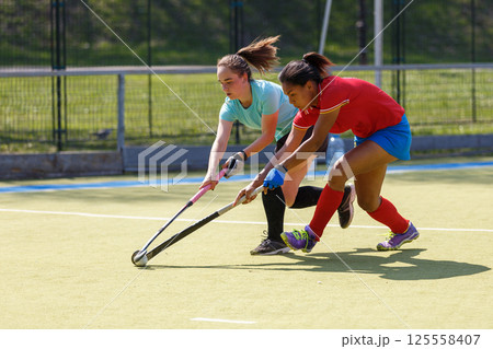 Two field hockey players fighting for the ball during the match 125558407