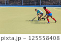 Two field hockey players fighting for the ball during the match 125558408