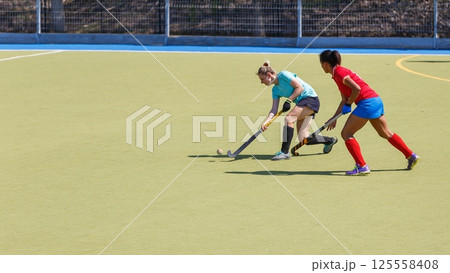Two field hockey players fighting for the ball during the match 125558408