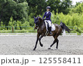 Young Equestrian Performing Dressage Test at Horse Riding Competition 125558411