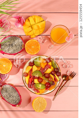 Fruit kitchen background with ingredients for making salad. Dragon fruit, mango, kiwi, orange, nuts and dried apricots, exotic fruits for a healthy lifestyle, advertising banner for a cafe, Fruit kitchen background with ingredients for making salad. Dragon fruit, mango, kiwi, orange, nuts and dried apricots, exotic fruits for a healthy lifestyle, advertising banner for a cafe, 125559454