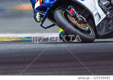 Road motorcycle racing, front wheel close up detail. Speed, circuit Road motorcycle racing, front wheel close up detail. Speed, circuit 125559485
