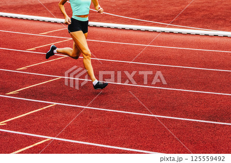 Run, track and fied banner with copy space. Running womans legs Run, track and fied banner with copy space. Running womans legs 125559492