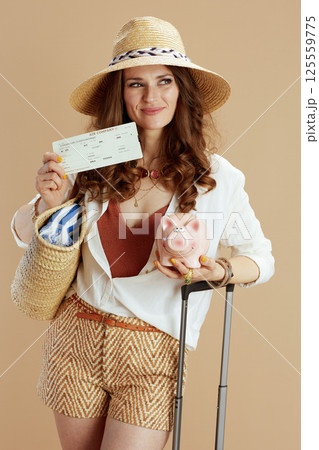 happy woman in blouse and shorts against beige happy woman in blouse and shorts against beige 125559775