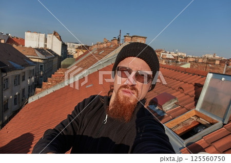 Selfie on a tiled rooftop 125560750