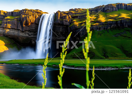 Waterfall with tall cliff and meadow. AI generation 125561091