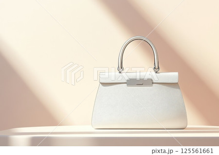 Elegant handbag with sleek leather and metallic accents on soft surface with gentle lighting 125561661