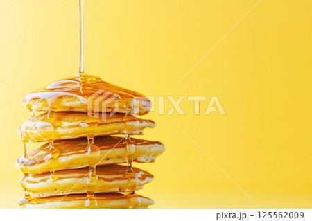 Flying pancakes stacked in mid air with syrup creating a delicious spectacle Flying pancakes stacked in mid air with syrup creating a delicious spectacle 125562009