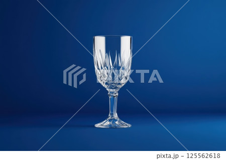 Elegant Czech crystal glass with detailed engravings on a deep blue background in refined style 125562618