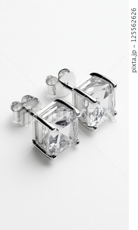 Minimalist platinum square shaped stud earrings on plain white background Minimalist platinum square shaped stud earrings on plain white background 125562626