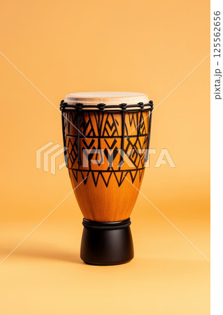 Intricate hand carved South African djembe drum with warm earthy tones and detailed tribal designs Intricate hand carved South African djembe drum with warm earthy tones and detailed tribal designs 125562656