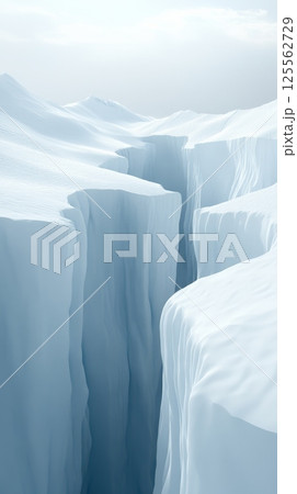 Sunlight illuminates a deep, narrow crevasse cutting through a pristine, snow covered landscape, creating a dramatic contrast of light and shadow in a remote arctic environment 125562729