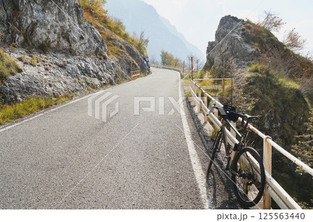 Bicycle on mountain road, mountainbike in the alp mountains autumn landscape. Extreme sport and biking concept, outdoors Bicycle on mountain road, mountainbike in the alp mountains autumn landscape. Extreme sport and biking concept, outdoors 125563440