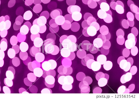 Abstract purple bokeh lights creating warm and festive atmosphere 125563542