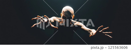 Emerging from the shadows, a terrifying zombie extends its arms, creating a chilling and suspenseful scene against a dark backdrop, capturing the essence of horror and the undead 125563606