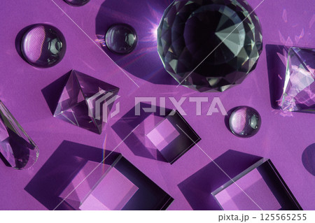 Crystal prism refracting light, magic crystals and pyramid, sphere and cube on purple background. Spiritual healing crystal practice. Feng Shui, good energy flow concept background.. 125565255