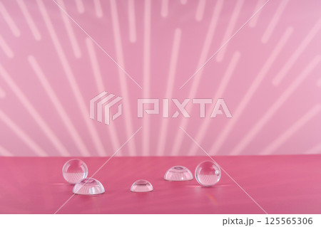 Cosmetic background podium for product presentation. Pink backdrop with transparent sphere decor, display balls mockup. Showcase mockup for perfume advertising, cosmetics stand 125565306