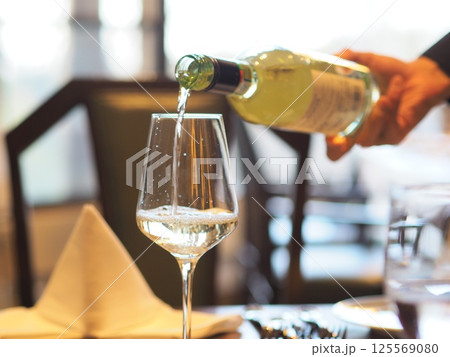 ソムリエがグラスにワインを注ぐ様子 ソムリエがグラスにワインを注ぐ様子 125569080