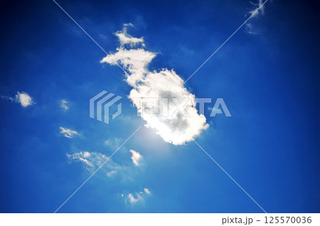 A cloud in the sky covers the sun at noon A cloud in the sky covers the sun at noon 125570036