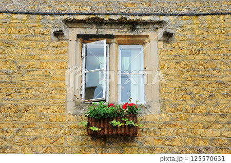 Photo of a window on a brick wall Photo of a window on a brick wall 125570631