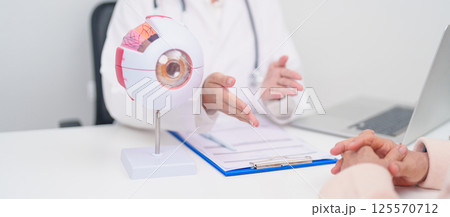 Elderly Patient consulting Doctor to Eye disease, Senior Medical Diagnosis. Anatomy Eye model for Cataract, Glaucoma, Age Related Macular Degeneration, Diabetic Retinopathy, Vitreous, health concept Elderly Patient consulting Doctor to Eye disease, Senior Medical Diagnosis. Anatomy Eye model for Cataract, Glaucoma, Age Related Macular Degeneration, Diabetic Retinopathy, Vitreous, health concept 125570712