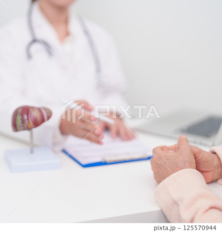 Doctor with human Liver anatomy. Elderly Patient consultation medical health for Liver cancer and Tumor, Jaundice, Viral Hepatitis, Cirrhosis, Failure, Enlarged, Hepatic Encephalopathy, Ascites Fluid Doctor with human Liver anatomy. Elderly Patient consultation medical health for Liver cancer and Tumor, Jaundice, Viral Hepatitis, Cirrhosis, Failure, Enlarged, Hepatic Encephalopathy, Ascites Fluid 125570944