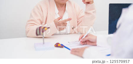 Doctor with human Liver anatomy. Elderly Patient consultation medical health for Liver cancer and Tumor, Jaundice, Viral Hepatitis, Cirrhosis, Failure, Enlarged, Hepatic Encephalopathy, Ascites Fluid 125570957
