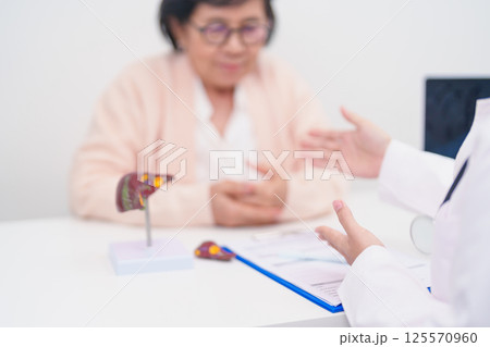 Doctor with human Liver anatomy. Elderly Patient consultation medical health for Liver cancer and Tumor, Jaundice, Viral Hepatitis, Cirrhosis, Failure, Enlarged, Hepatic Encephalopathy, Ascites Fluid 125570960