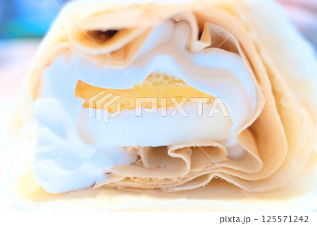 チーズケーキとホイップクリームを包んだクレープの断面 125571242
